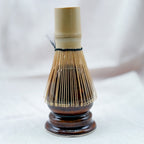 Traditional Japanese tea whisk on a white background